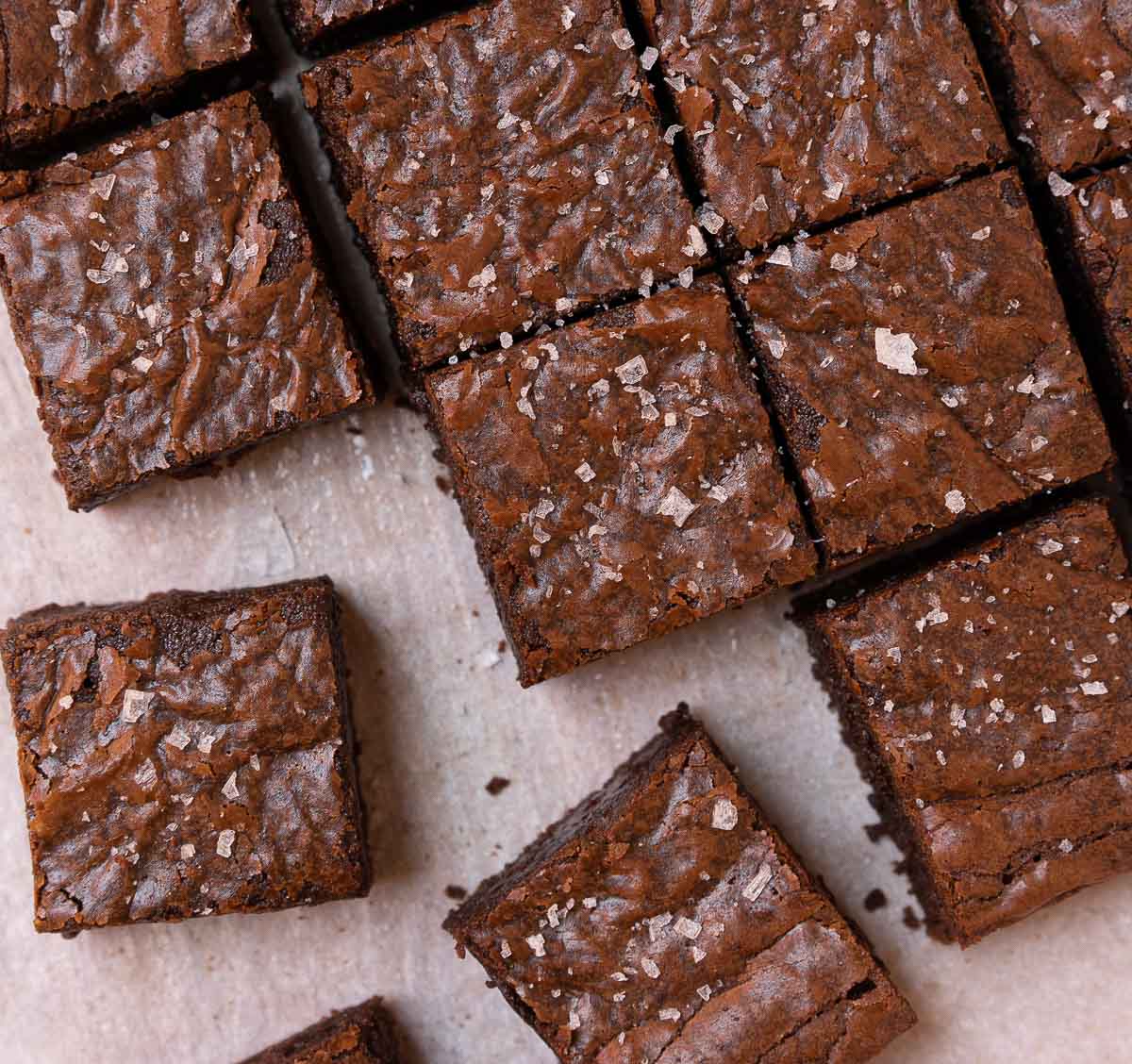 brownies sliced into squares and topped with flaky sea salt.