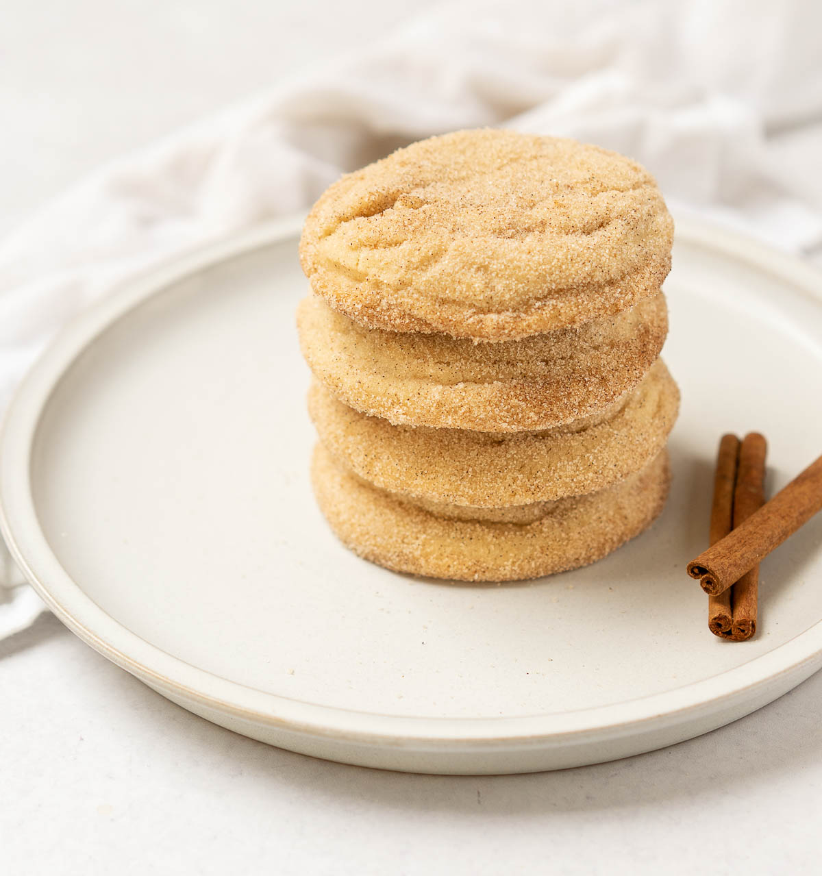 cinnamon cookies stacked upon each other on a plate.