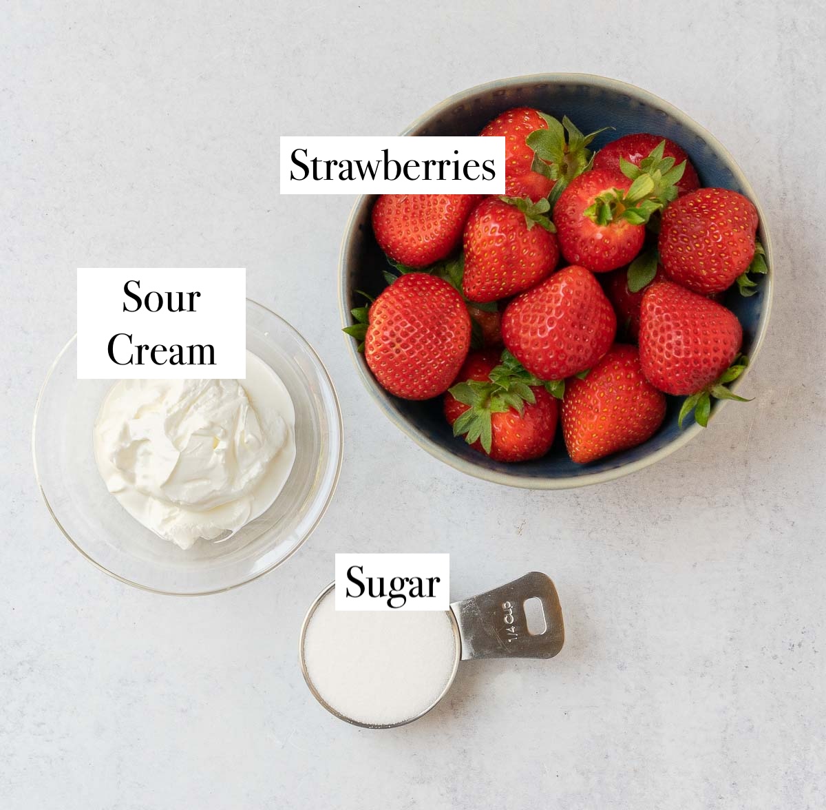 ingredients for fresas con cream, strawberries, sour cream and sugar.