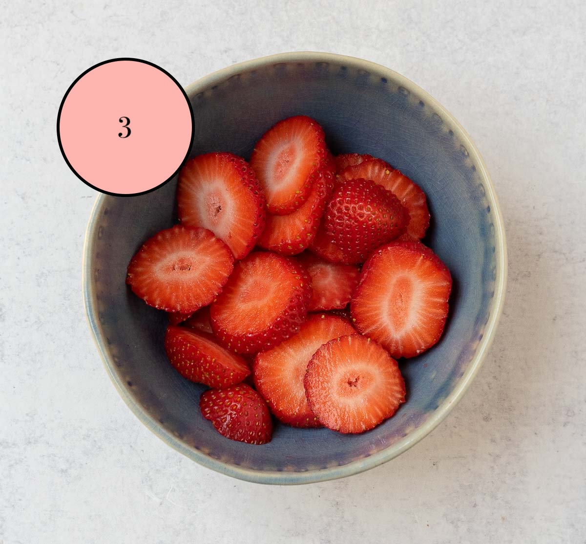 sliced strawberries in a bowl.