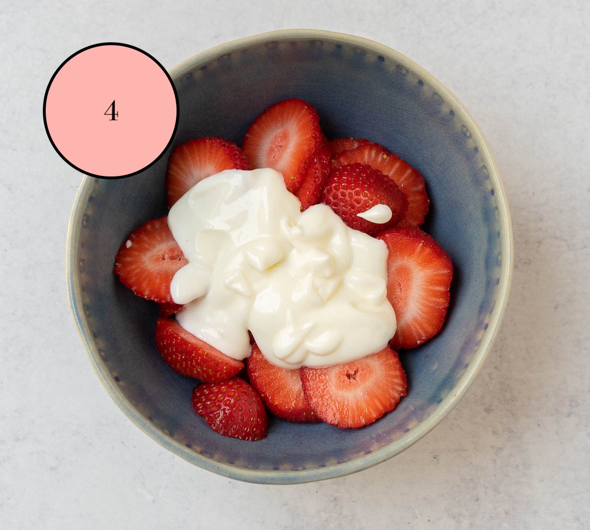 sliced strawberries with sour cream and sugar mixture on top.