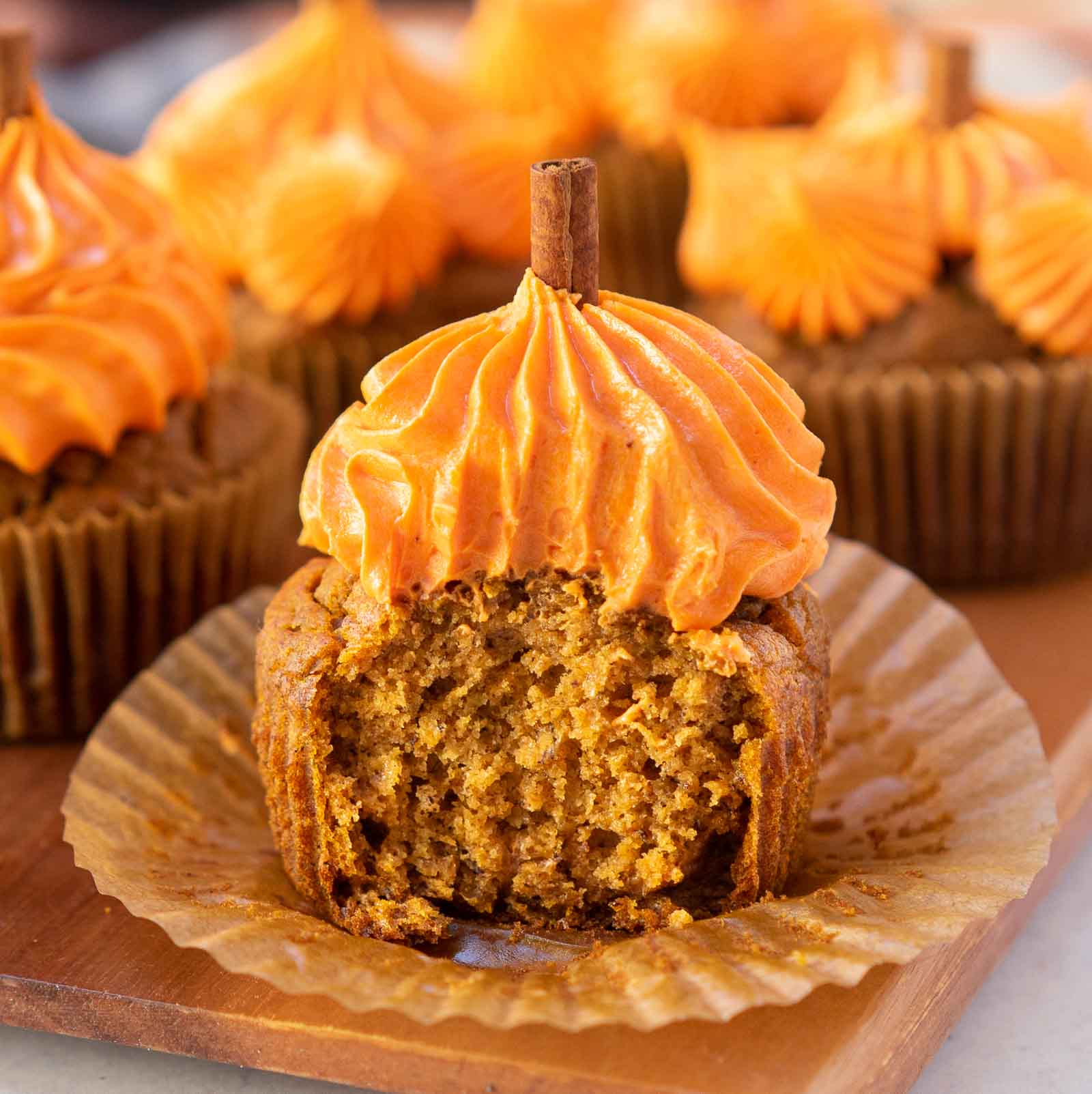 banana pumpkin muffins with vanilla buttercream frosting on top.