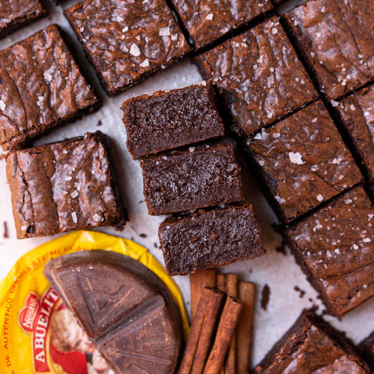 mexican hot chocolate brownies with cinnamon and showing fudgy center.