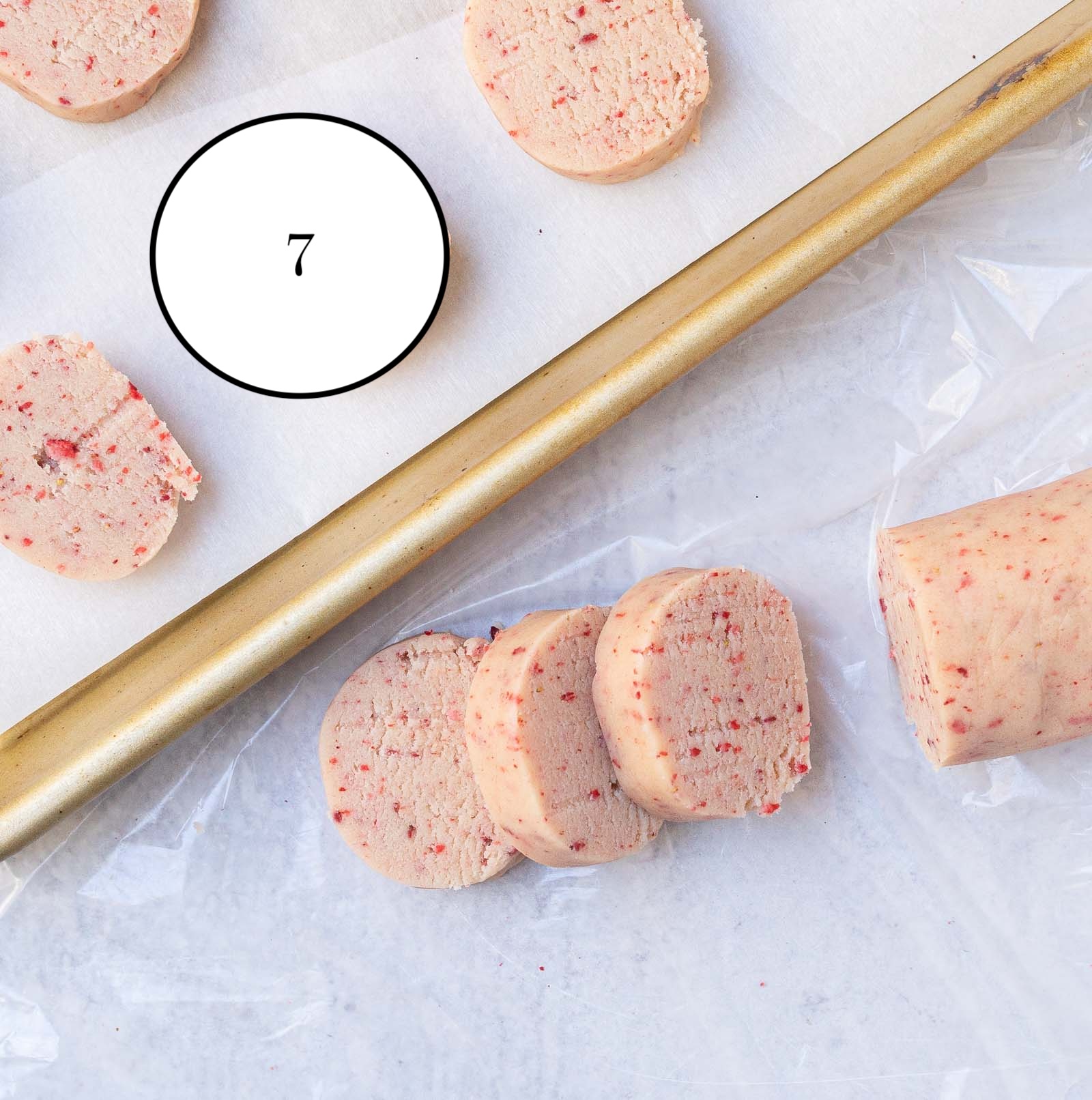 strawberry shortbread cookies sliced and placed on baking sheet before baking. 