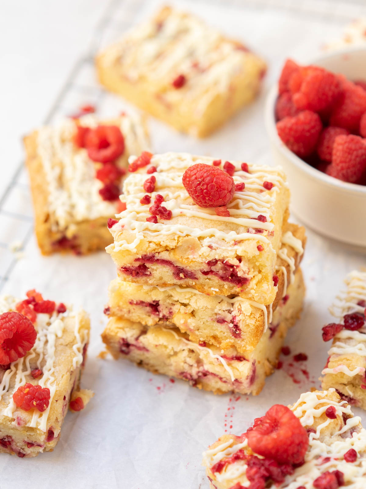 White chocolate and raspberry blondies stacked on one another.