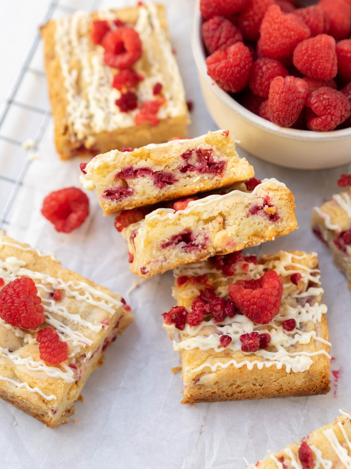 white chocolate and raspberry blondies on wire rack.