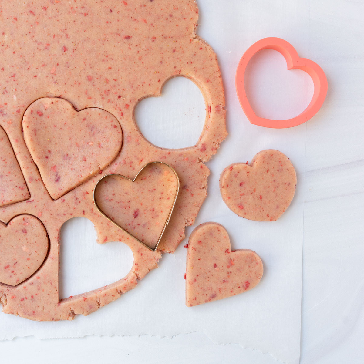 strawberry cut-out sugar cookies shaped as hearts.