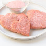 strawberry cut-out sugar cookies on plate.