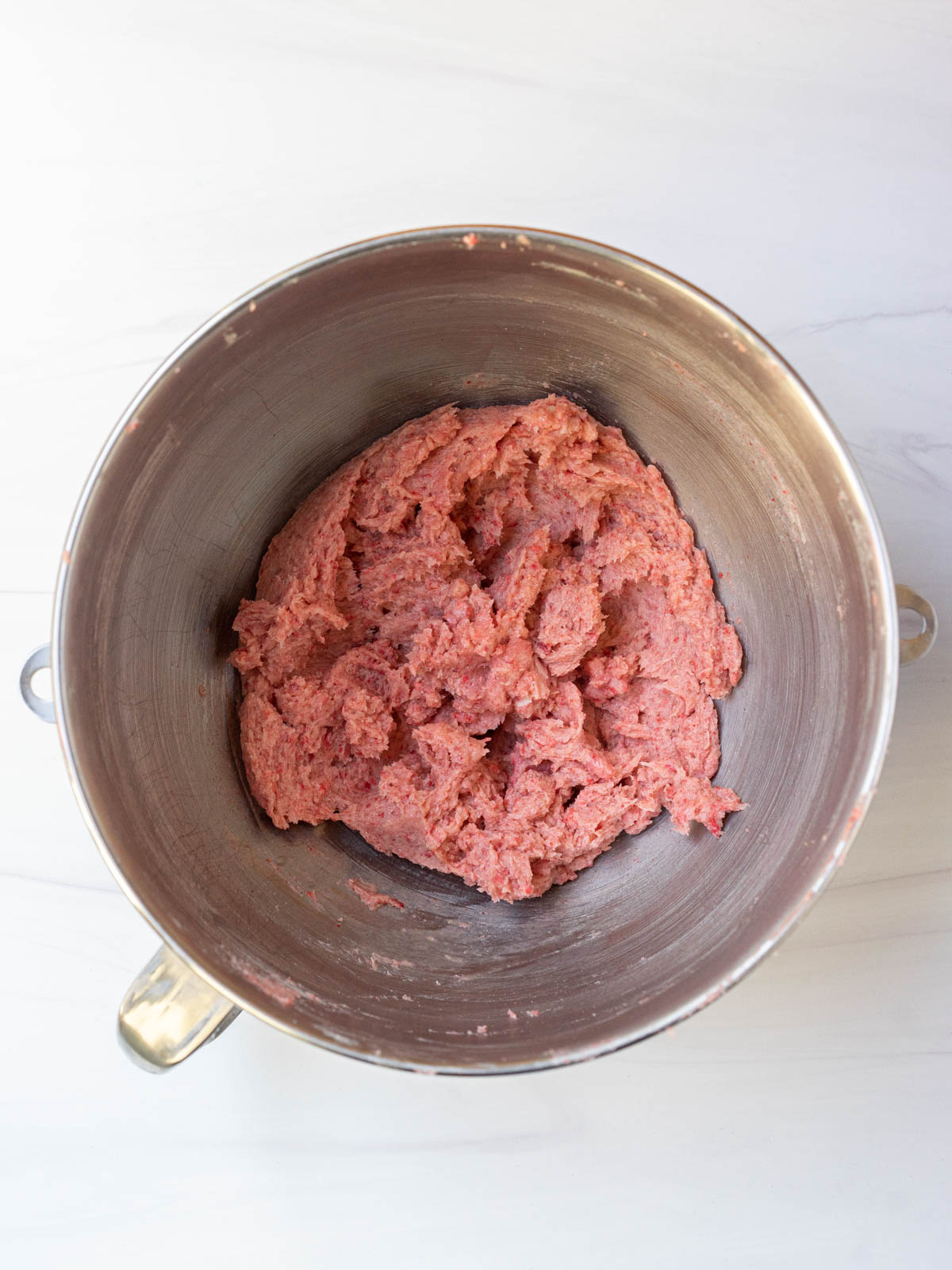 strawberry dough mixed together in mixing bowl.