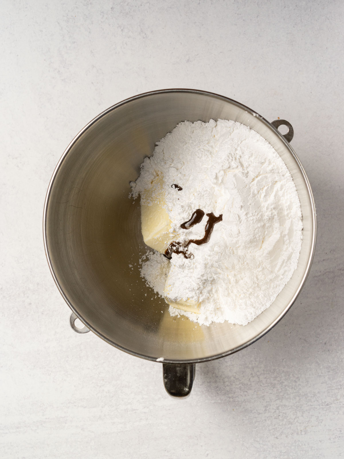 confectioner's sugar, butter and vanilla extract in mixing bowl.