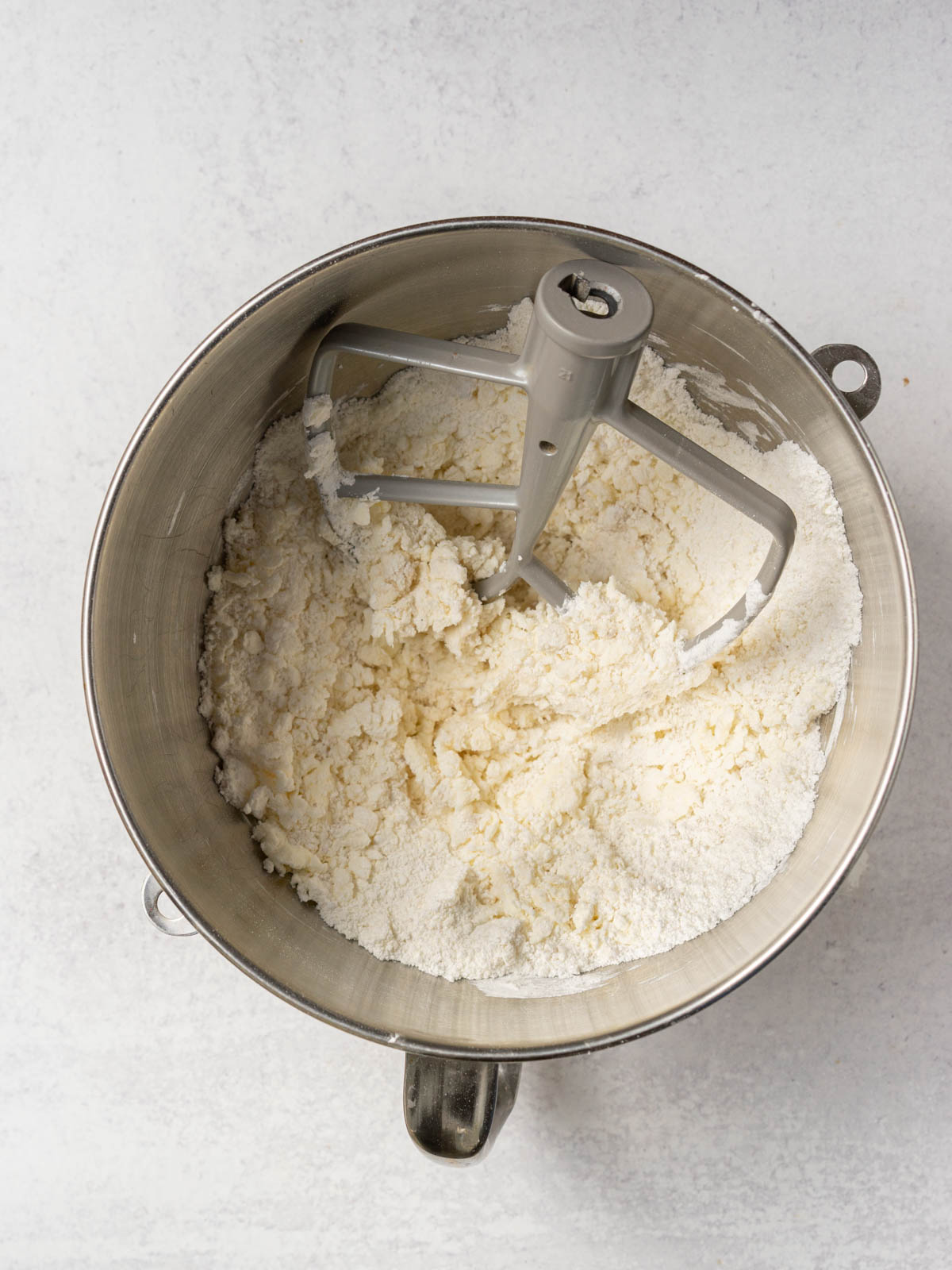 ingredients being mixed in mixing bowl with paddle attachment.