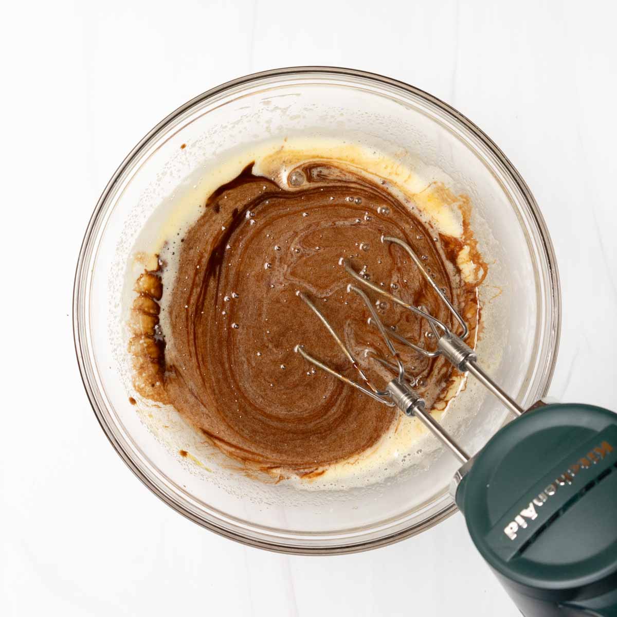 Whisking in chocolate butter mixture to egg sugar mixture.