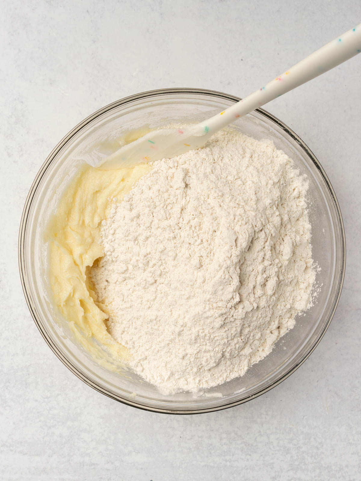 adding dry ingredients to wet ingredients.
