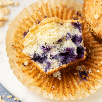 blueberry muffin in half displaying inside.