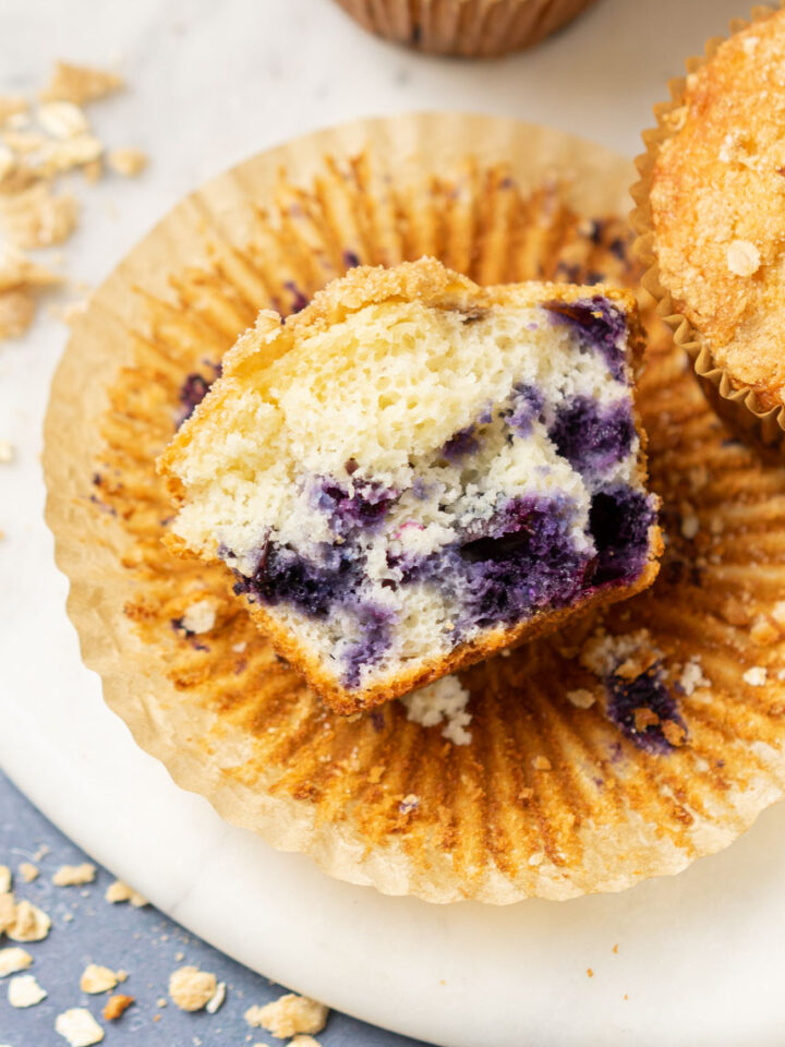 blueberry muffin in half displaying inside.