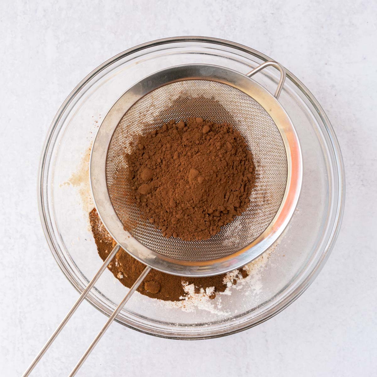 sifting cocoa powder.